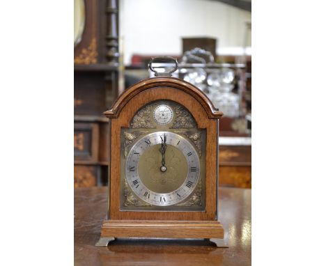 A George II design mahogany mantel clock, by Elliott, brass carrying handle and bracket feet