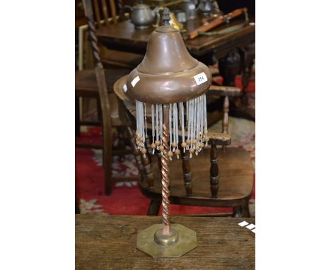 A copper & Brass table lamp with copper shade, a twisted column on a brass octagonal base 