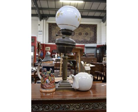 An Edwardian oil lamp; a German stein; a teapot