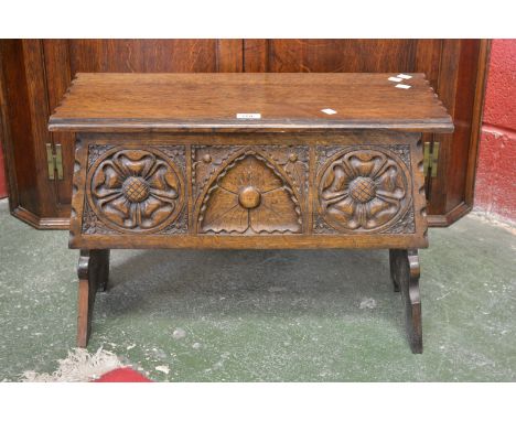 An oak blanket box, carved panel front
