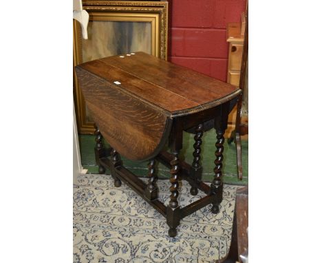 An early 20th century oak gate-leg dining table, oval top, barley-twist supports, c.1910.