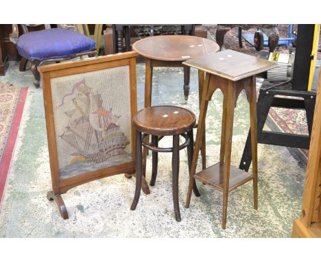 A woolwork oak framed firescreen; a bentwood stool; a mahogany jardiniere stand; a mahogany occasional table, circular crossb