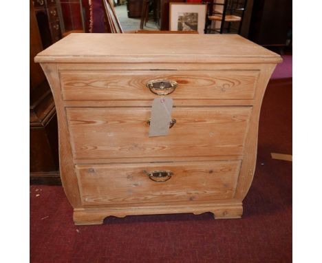 An early 19th century Continental Biedermeier pine commode, with three drawers, raised on bracket feet, H.68 W.70 D.41cm 