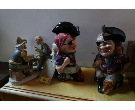 A pair of pirate toby jugs and a figural group of men playing cards, H.26cm 