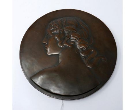 A bronzed ceramic wall plaque 
