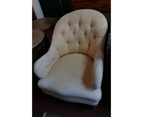 A 19th century mahogany armchair in the manner of Howard &amp; Sons, in button backed apricot woven upholstery, on turned fro