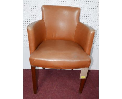 A tub style tan faux leather and brass studded desk chair 