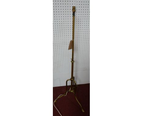 A 19th century brass adjustable lamp, on tripod base and pad feet 