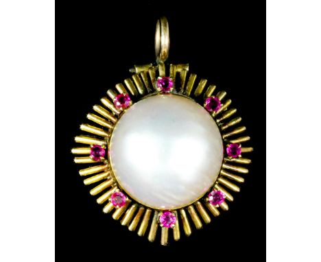 A 20th Century gold coloured metal mounted pearl and ruby pendant, set with baroque pearl surrounded by eight small rubies, 3