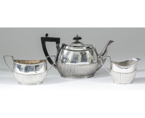 A late Victorian/George VI harlequin silver bachelors oval three-piece tea service with part reeded bodies, all by James Dixo