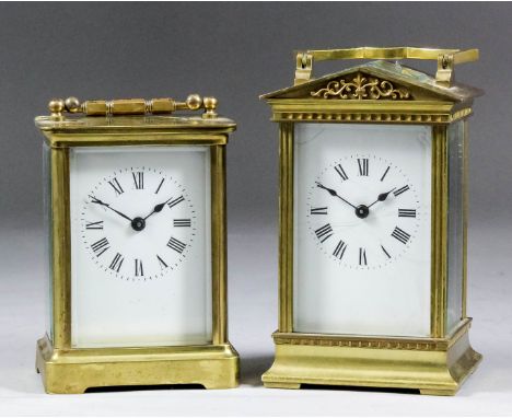 Two early 20th Century French carriage timepieces, both with white enamel dials with Roman numerals, to the eight day movemen