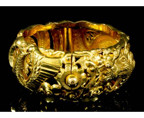 A modern Chinese cast 22ct gold bangle in the form of a serpent and bird, 56mm diameter (gross weight 91 grammes) Note: Stamp
