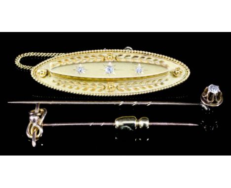 A 15ct gold and gem set oval brooch, set with three central white stones in star mount and with flowers and leaves to border,