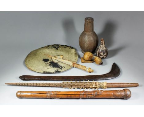 A small collection of African artefacts collected sometime in the early 20th Century, including - a blackwood club of curved 