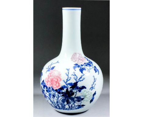 A Chinese blue and white porcelain bottle vase, decorated with flowering chrysanthemums, the flower heads enamelled in colour