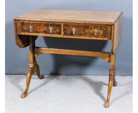 A walnut sofa table of "18th Century" design, the top with shaped leaves, crossbanded and with moulded edge, fitted two real 