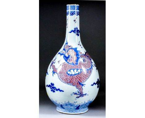 A Chinese blue and white and copper red porcelain bottle vase, decorated with a four-clawed dragon chasing the sacred pearl, 