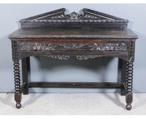 A 19th Century carved "Black Oak" rectangular side table, the upstand with carved scroll pediment, fitted one frieze drawer w