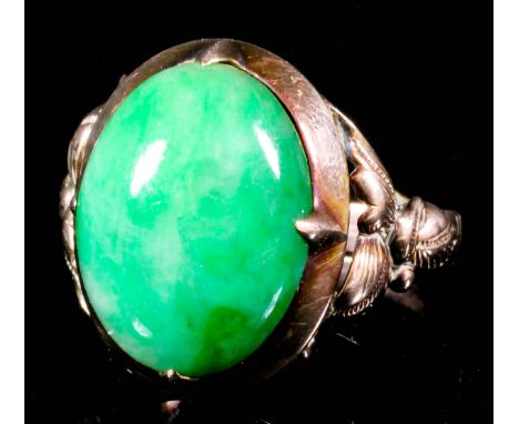 A 14ct gold mounted jade ring, set with an oval cabochon stone, approximately 15mm x 12mm (size U+ - gross weight 4.6 grammes