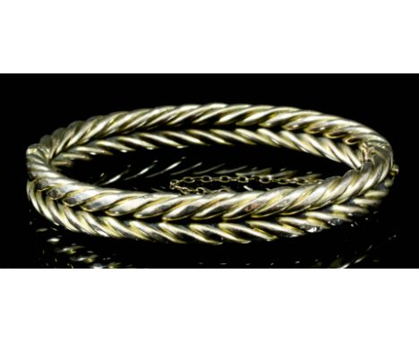 A modern 15ct rose gold rope twist pattern stiff bangle, 56mm diameter (gross weight 21 grammes)