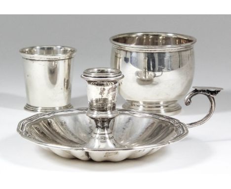 A Continental silvery metal circular chamber candlestick with shaped and moulded rim, 2.75ins high (stamped "800 standard"), 