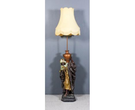 A Victorian painted pottery cast iron and copper standard lamp in the form of a standing Arab holding a vessel, on cast iron 