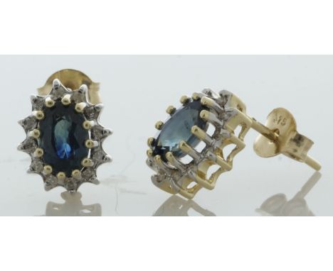 These 9ct yellow gold stud earrings have an oval 6mm x 4mm sapphire with a halo of round brilliant cut diamonds surrounding i