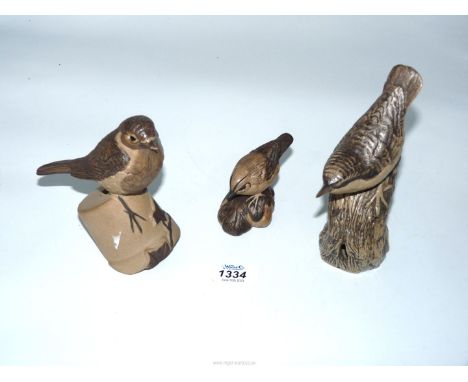 Three Poole Pottery birds including Robin on a flowerpot,(chip to beak) Tree creeper and Wren.