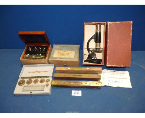 A students Microscope, two sets of weights and three spirit levels.