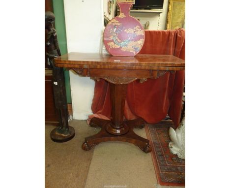 A 19th century Regency design Mahogany flap over card table standing on a tapering octagonal pillar raised on a platform base