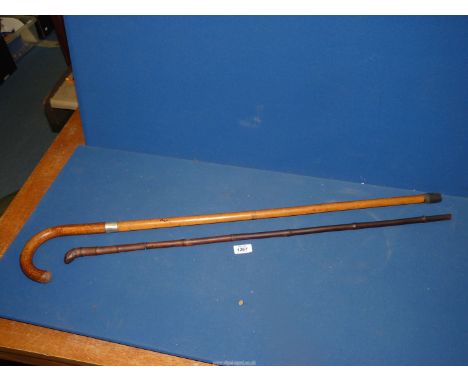 A bamboo cased sword stick, plus another sword stick having a silver collar, blade (a/f).