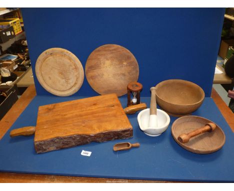 A quantity of Kitchenalia including heavy rustic chopping board, two bread boards, two wooden bowls, egg timer, pestle and mo