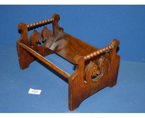 An Oak book trug with stylised heads having bobbin work to the ends.