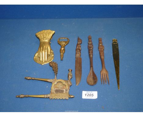 A carved wood knife, fork and spoon, brass bottle opener, nutcracker, paper knife, etc.