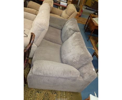 A modern dark beige cord pattern upholstered 2/3 seater settee.