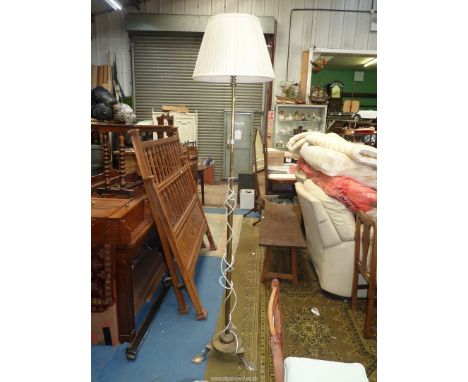An art nouveau Brass Standard Lamp having a column adjustable for height, the base with three feet in the form of leaves of s