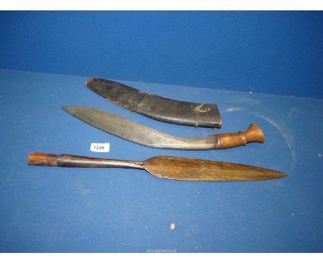 A 19th century Zulu Spear head, covered with old protective grease, 18 1/2" to socket end, and a Gurkha Kukri with carved woo