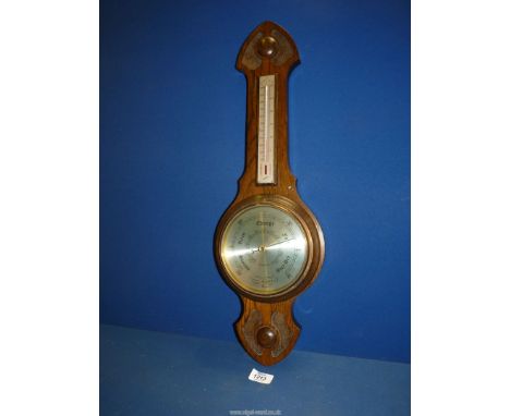An oak cased Aneroid Barometer, 30'' long.
