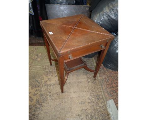 An Edwardian Mahogany/Walnut Envelope Table opening to reveal a card table lined with green baize and four counter recesses, 