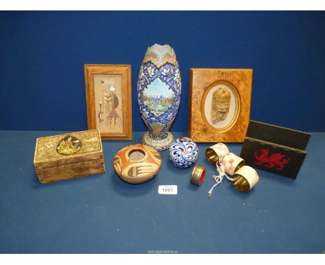 A small quantity of miscellanea including a framed carved stone face of a smiling man, enamel vase, Cigarillos box, a 'Hunch 