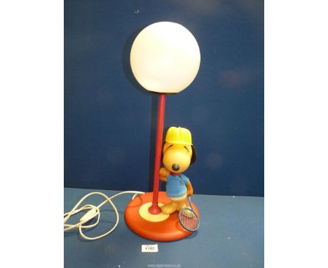 A circa 1960's 'Snoopy' table lamp in tennis kit (marks and wear to clothes), with globe shade, 20 1/2'' tall.