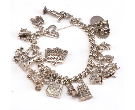 Silver charm bracelet, silver curb link bracelet, with nineteen charms, including opening lighthouse, an opening purse with l