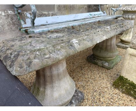 A composite stone garden bench, 136 cm wide