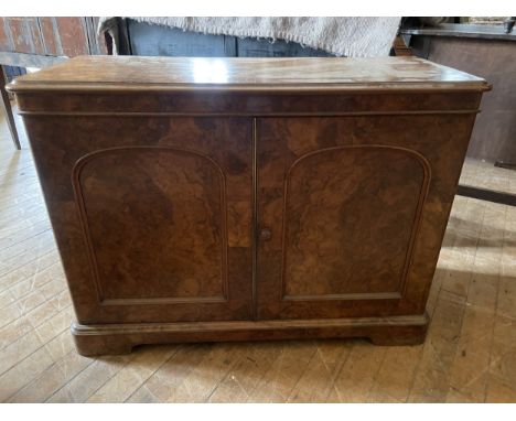 A 19th century walnut two door cabinet, stamped Wilkinson & Sons, 98 cm wideHeight 74 cmVariation of colour, marks to the top