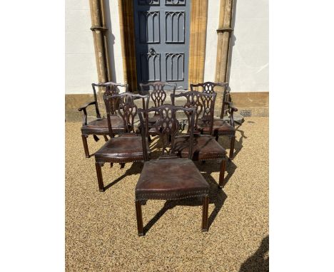 A set of six George III style mahogany dining chairs, with pierced vase shaped spats, leather upholstered seats and on chamfe