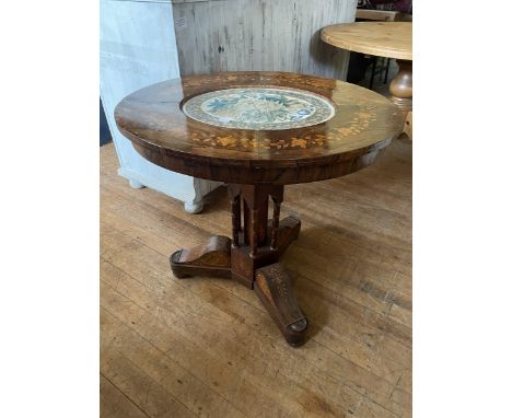A Continental rosewood oval table, with marquetry inlaid decoration, the top inset with an oval panel painted flowers, on a c