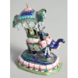 A SMALL INDIAN ENAMELLED SILVER ELEPHANT FIGURE, with riders, 9cm high.