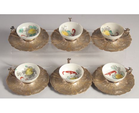 SIX CHINESE PORCELAIN CUPS WITH TURKISH OTTOMAN SILVER SAUCERS and mounted handles, porcelain cup 6cm diameter, silver saucer