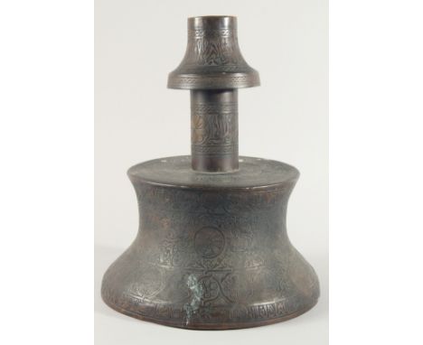 A VERY LARGE ISLAMIC ENGRAVED BRASS CANDLESTICK, with decorative roundels of floral motifs and calligraphy, 42cm high.