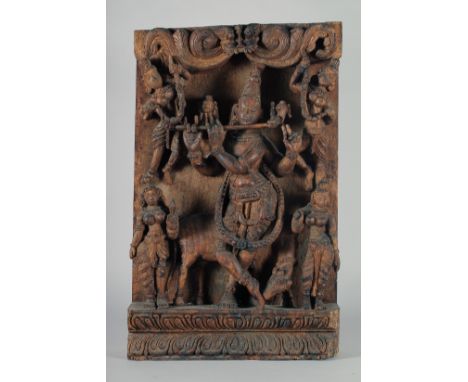 A LARGE INDIAN CARVED WOODEN PANEL, with central deity playing a musical instrument surrounded by four smaller figures, 64cm 